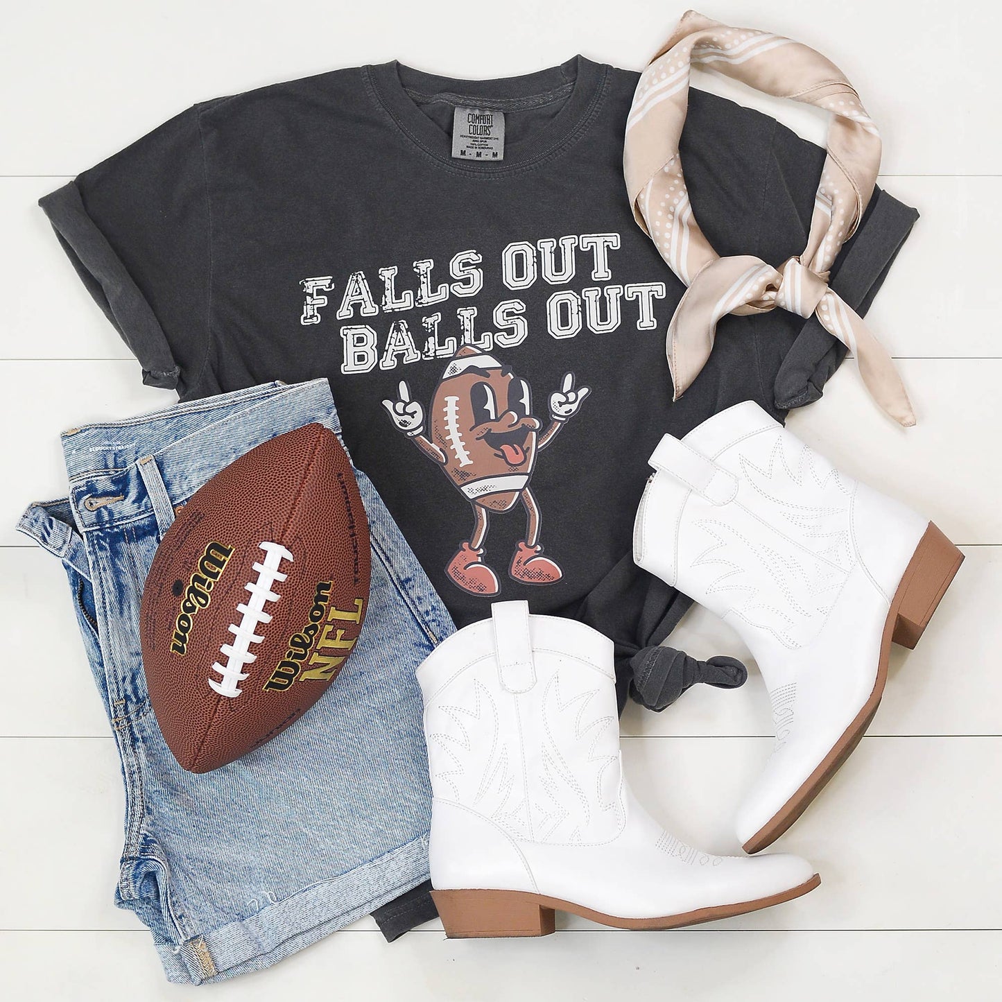 Edgy game day tee with bold 'Falls Out Balls Out' graphic, styled casually.