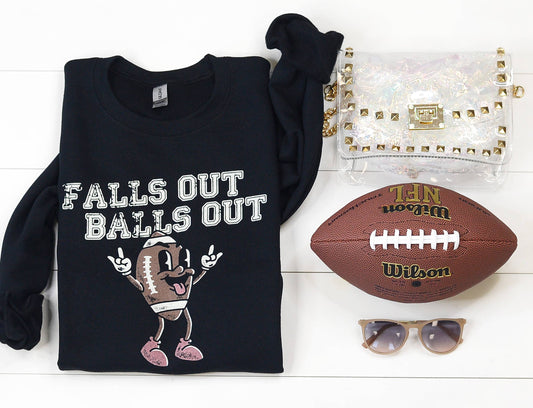 Vintage black football falls out balls o sweatshirt with cheeky graphic, styled with denim and sneakers.