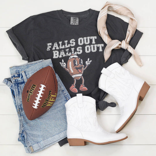 Edgy game day tee with bold 'Falls Out Balls Out' graphic, styled casually.