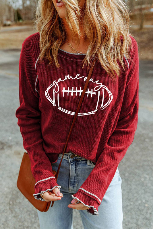 Red Game day waffle knit long sleeve top styled for game day with casual bottoms and accessories.