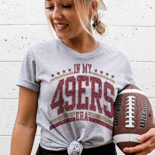 Graphic tee with in my 49ers era tee-inspired text, styled for game day with denim or joggers.