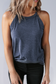 High-neck cropped tank with ribbed fabric, styled solo or layered under jackets.