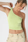 Ribbed one-shoulder cropped tank in soft fabric, styled with jeans or skirts.